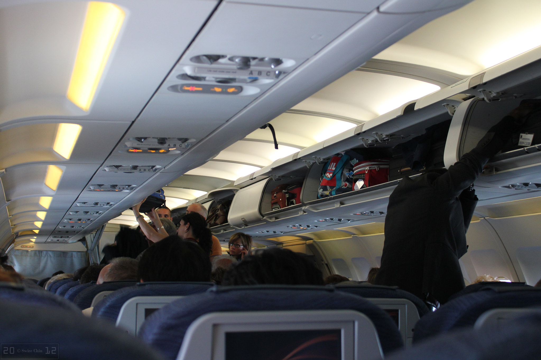 Stop Doing These 20 Things at the Airport Before You Annoy Everyone Around You 9 Can Pac Swire Overloading Overhead Bins